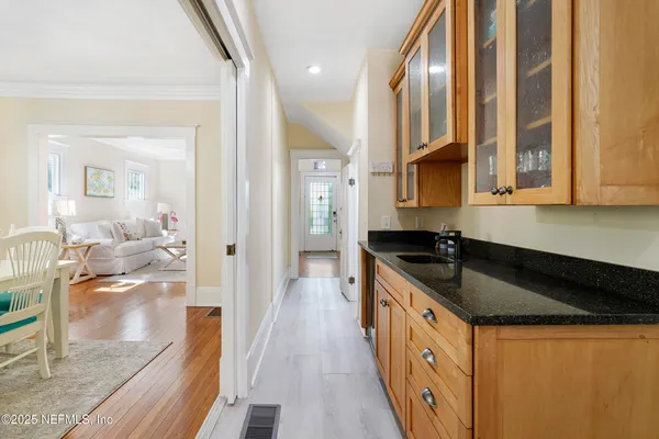 a kitchen with a table chairs microwave and cabinets