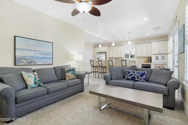 a kitchen with granite countertop a center island stainless steel appliances cabinets and a window