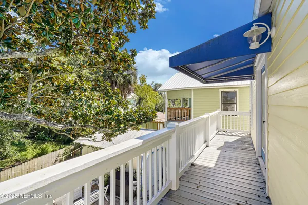 a view of a balcony with wooden floor