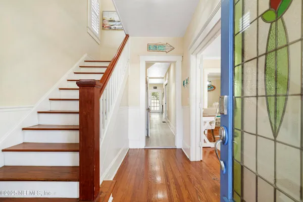 a view of entryway and hall with wooden floor