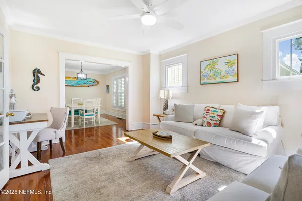 a living room with furniture and wooden floor
