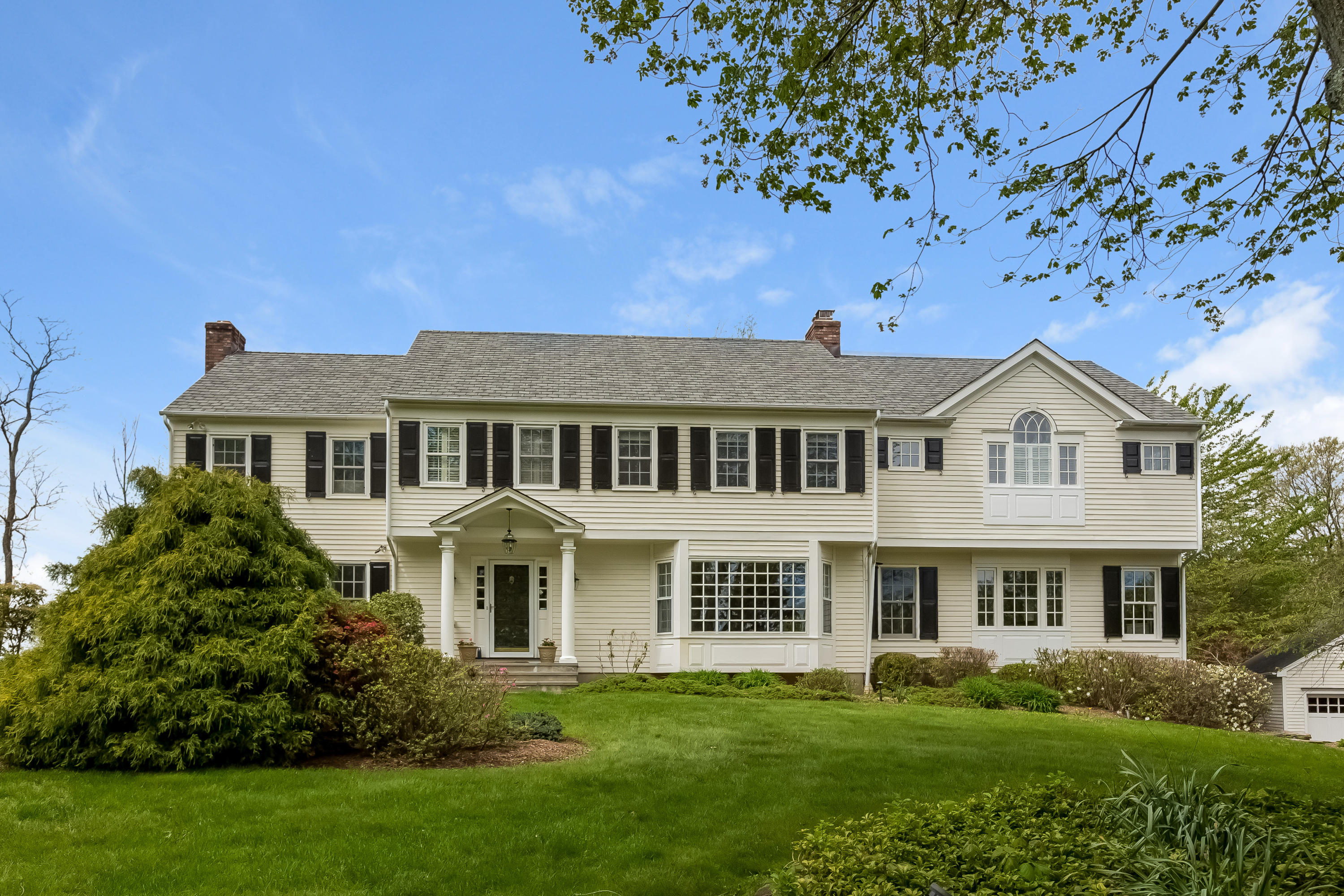 a front view of a house with a garden