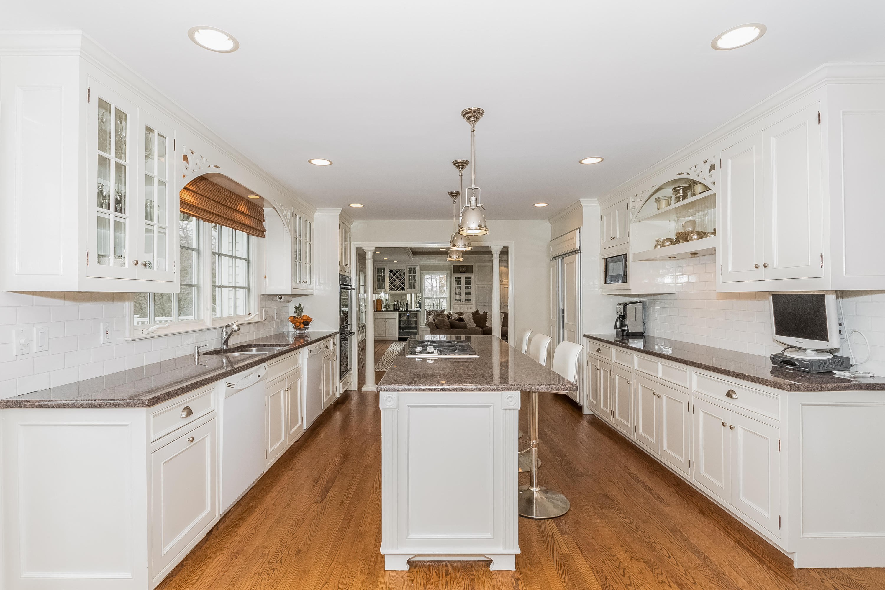 71 Peach Hill Road Darien, CT 06820 - Photo 11 of 42 a large kitchen with stainless steel appliances lots of counter space and wooden floor