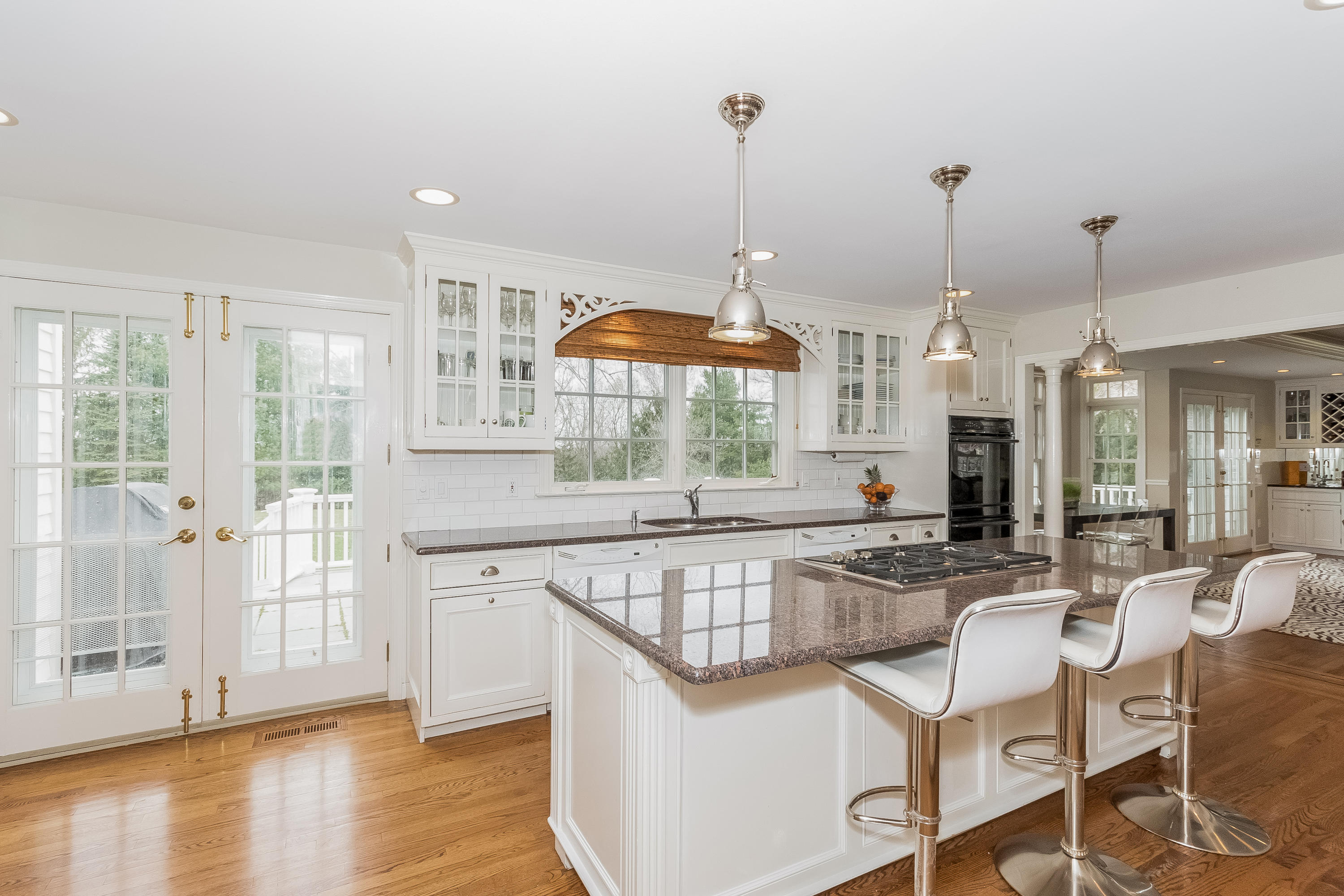 71 Peach Hill Road Darien, CT 06820 - Photo 12 of 42 a kitchen with stainless steel appliances granite countertop a stove and a wooden floors