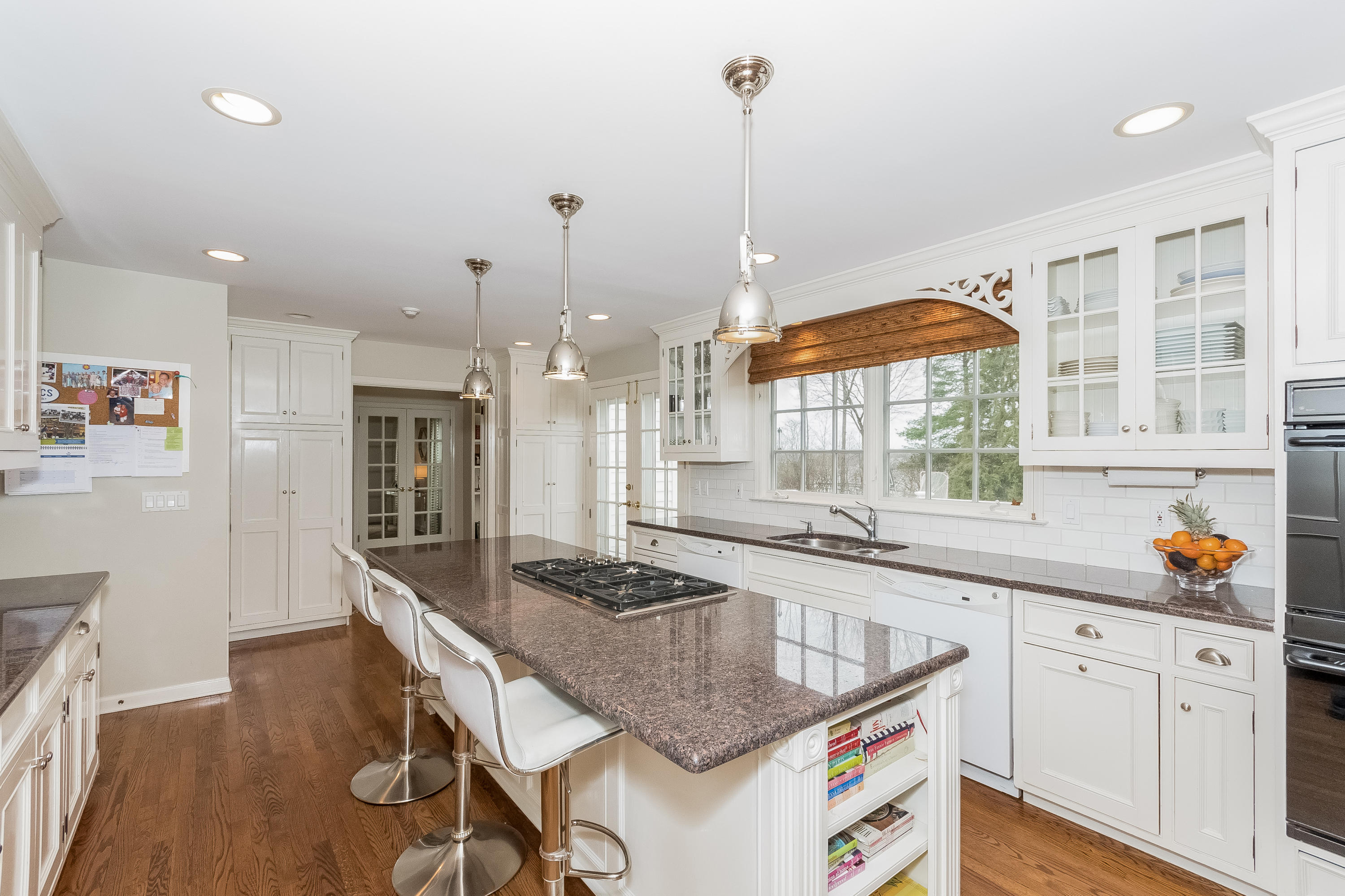 71 Peach Hill Road Darien, CT 06820 - Photo 13 of 42 a kitchen with stainless steel appliances granite countertop a sink a stove and a wooden floors