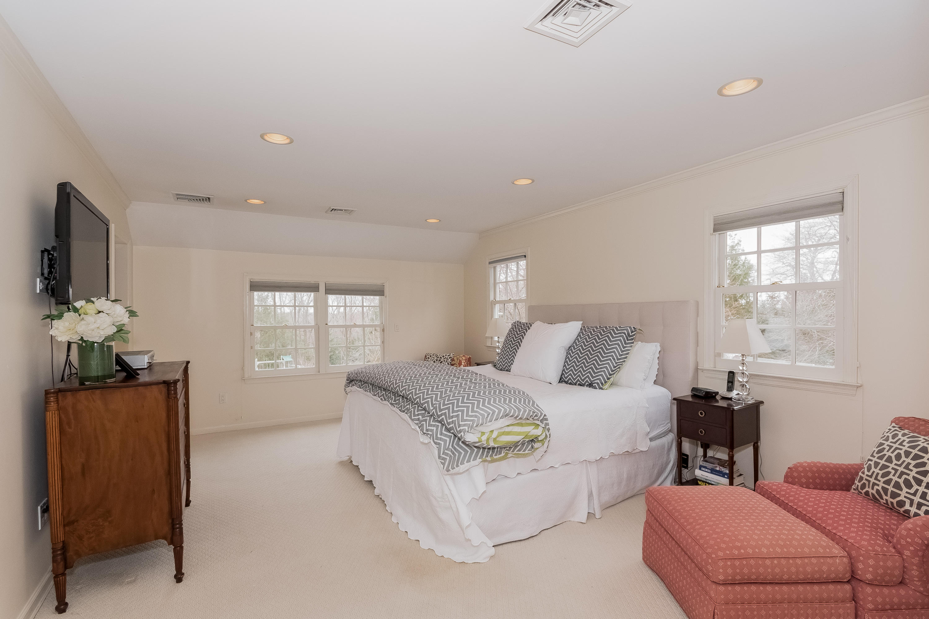 71 Peach Hill Road Darien, CT 06820 - Photo 18 of 42 a spacious bedroom with a bed and a couch