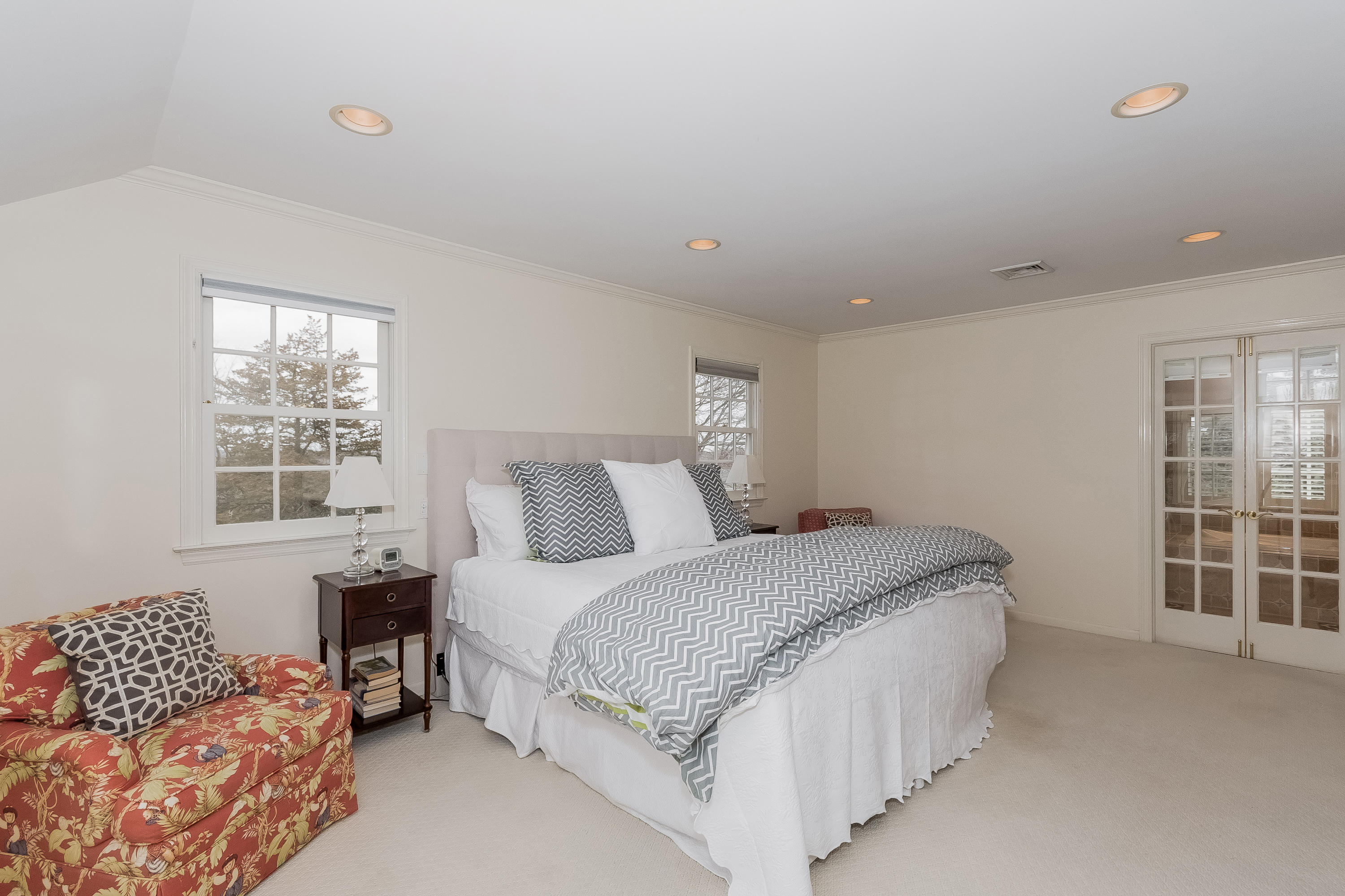 71 Peach Hill Road Darien, CT 06820 - Photo 19 of 42 a spacious bedroom with a bed and a couch