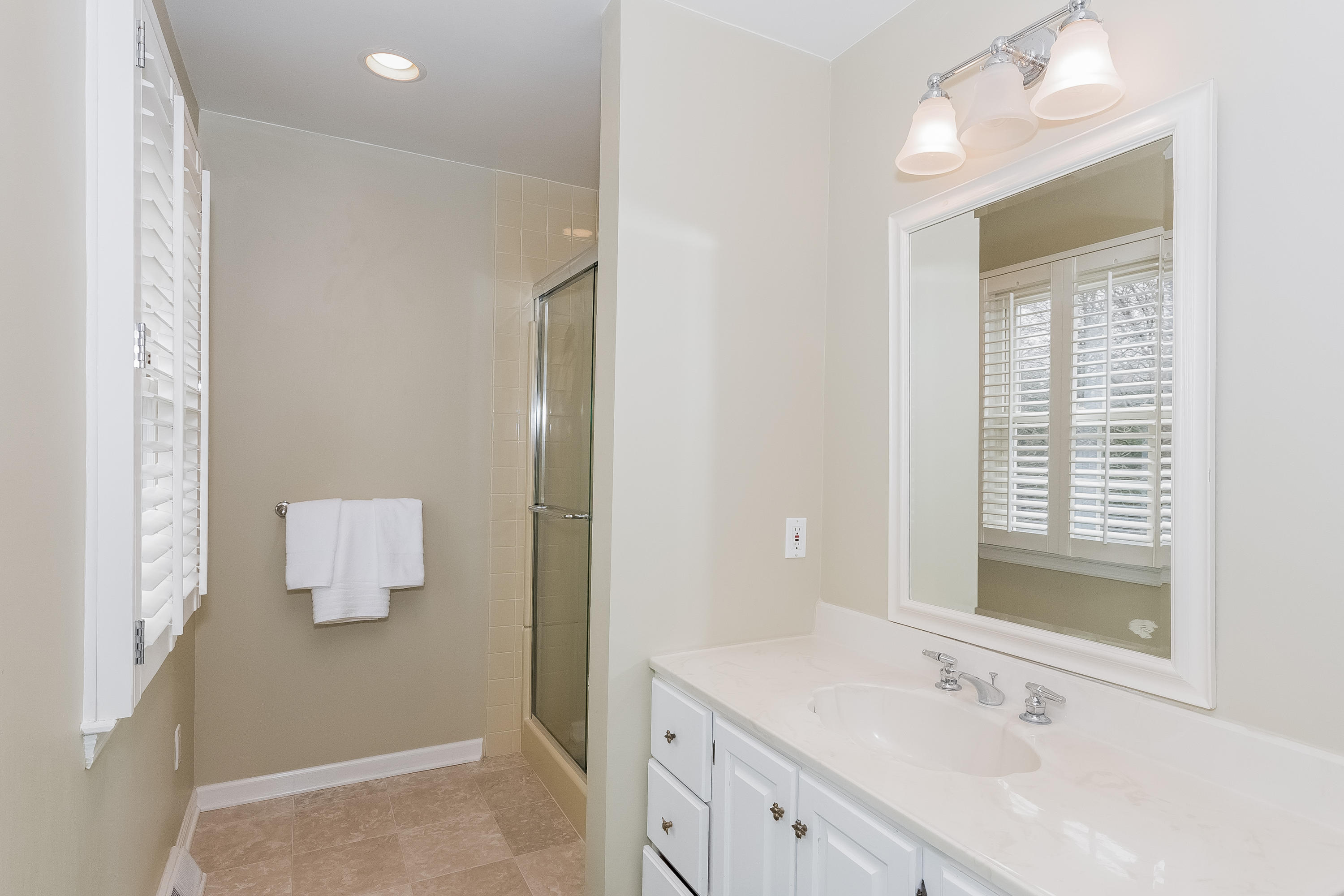 71 Peach Hill Road Darien, CT 06820 - Photo 26 of 42 a bathroom with a sink a mirror and a shower