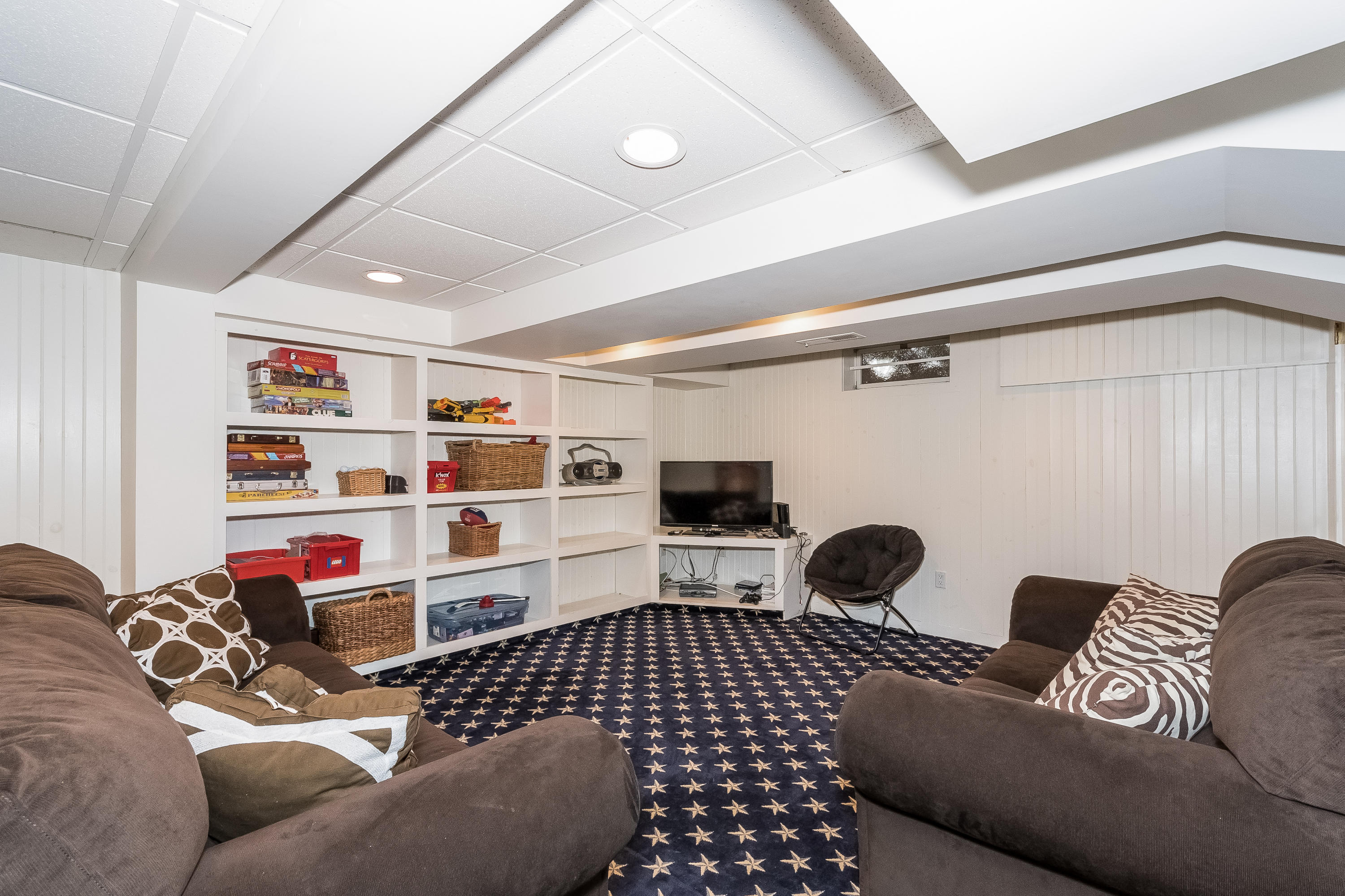 71 Peach Hill Road Darien, CT 06820 - Photo 29 of 42 a living room with furniture cabinets and a window