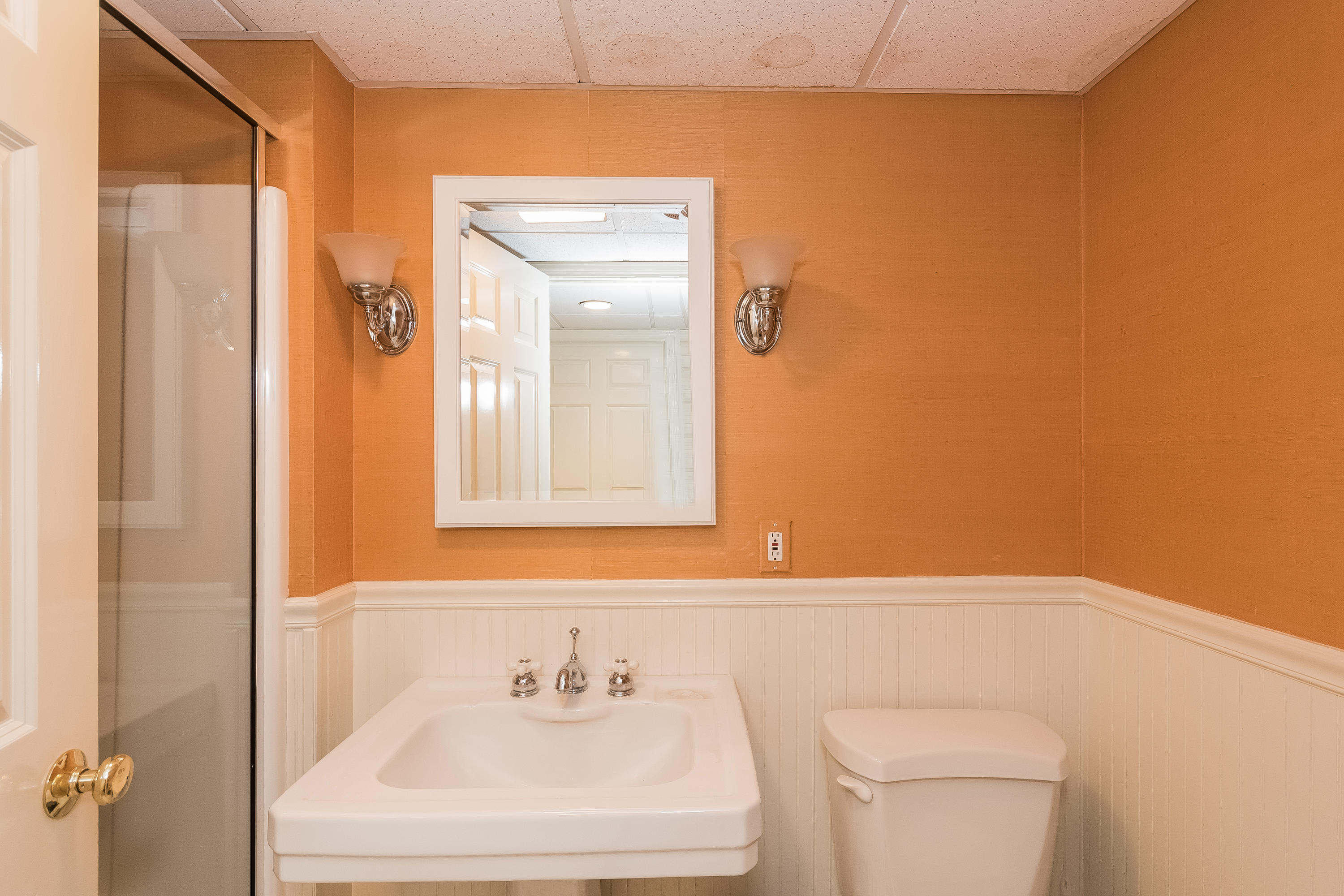 71 Peach Hill Road Darien, CT 06820 - Photo 32 of 42 a bathroom with a sink a toilet and a mirror