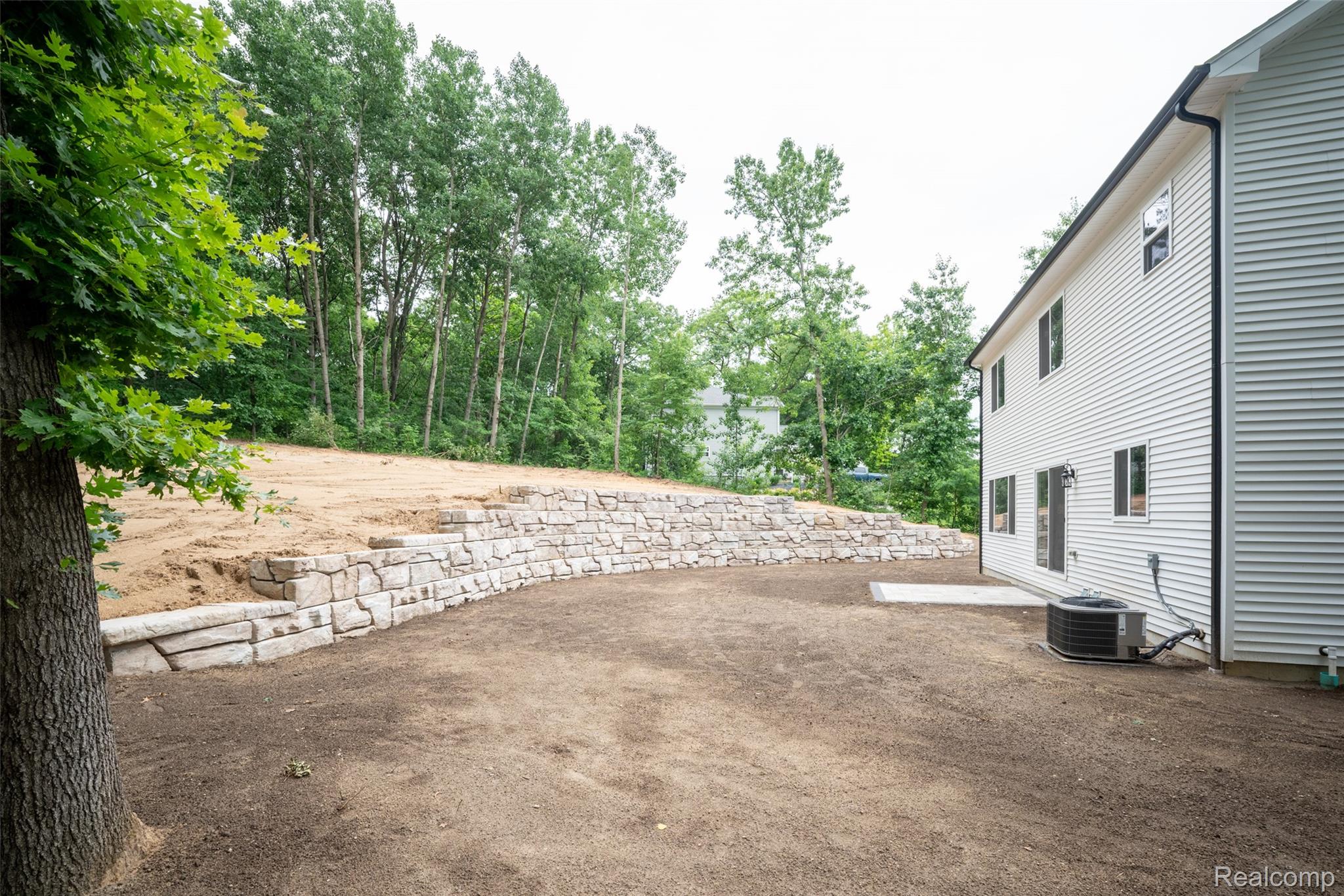 16085 Catalpa Ridge Holly, MI 48442 - Photo 29 of 40 Expansive backyard with a curved stone retaining wall
