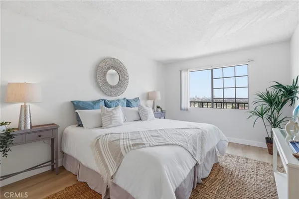 a bedroom with bed and a large window
