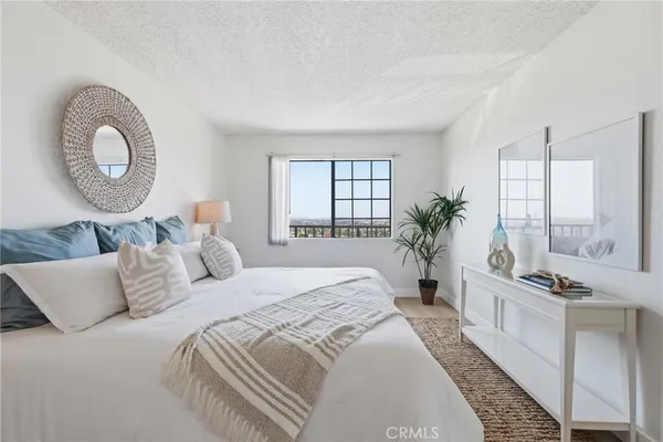 a bedroom with a bed and a potted plant