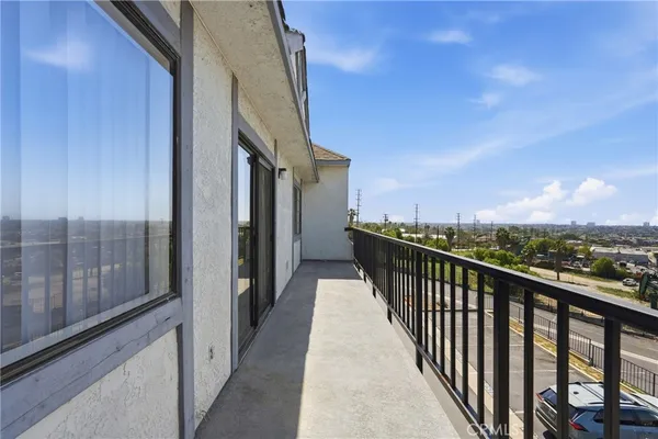 a view of a balcony with wooden floor and fence