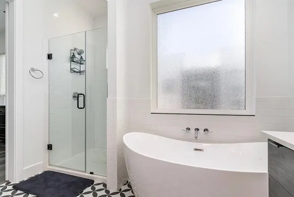 a bathroom with a bathtub and shower