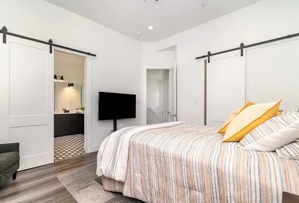 a kitchen with a dining table chairs stainless steel appliances and cabinets