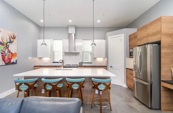 a living room with furniture and kitchen view