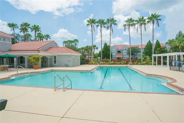 a swimming pool with outdoor seating and yard