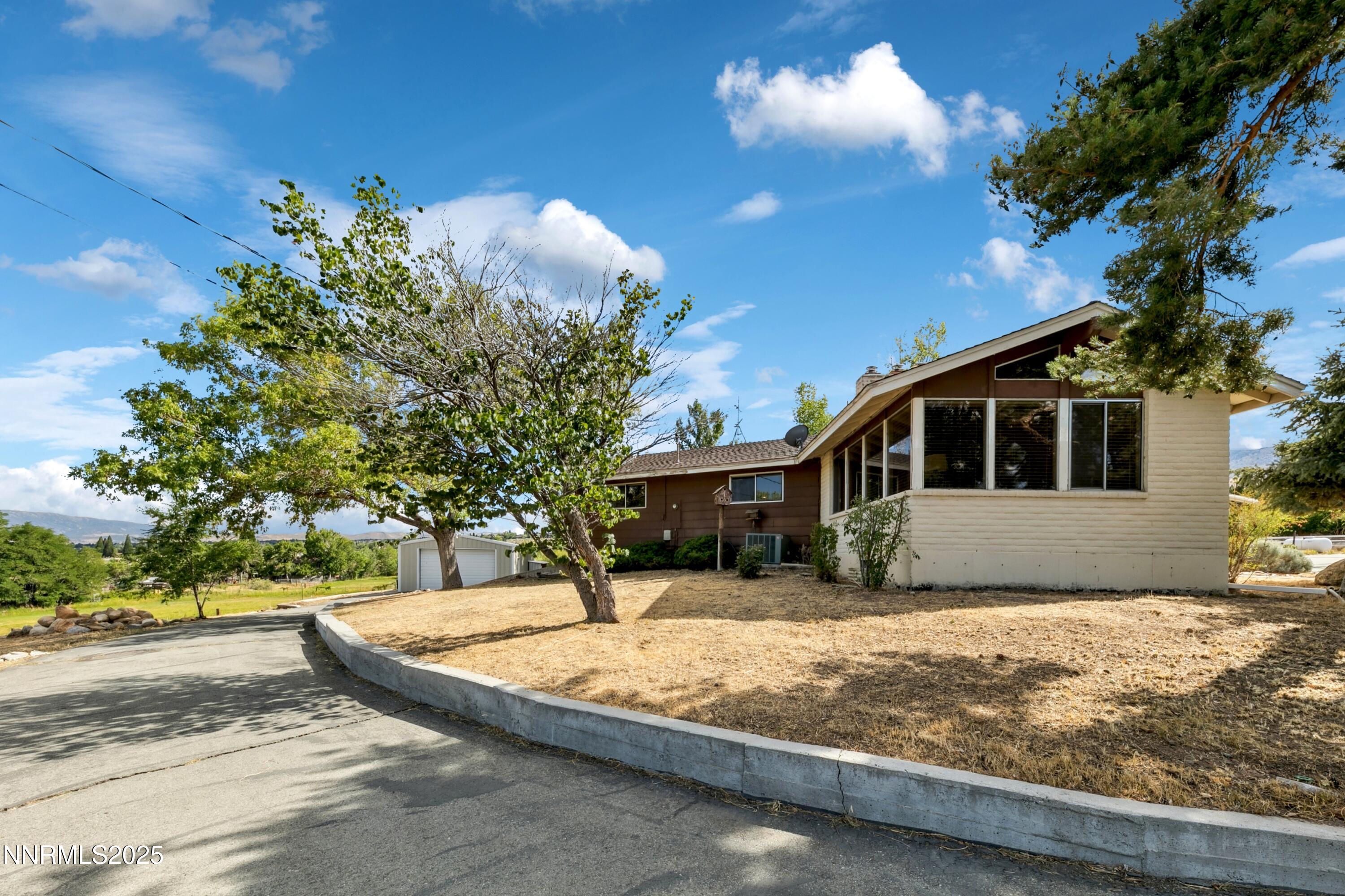 3550 Lone Tree Lane Reno, NV 89511 - Photo 23 of 40 a front view of a house with a yard