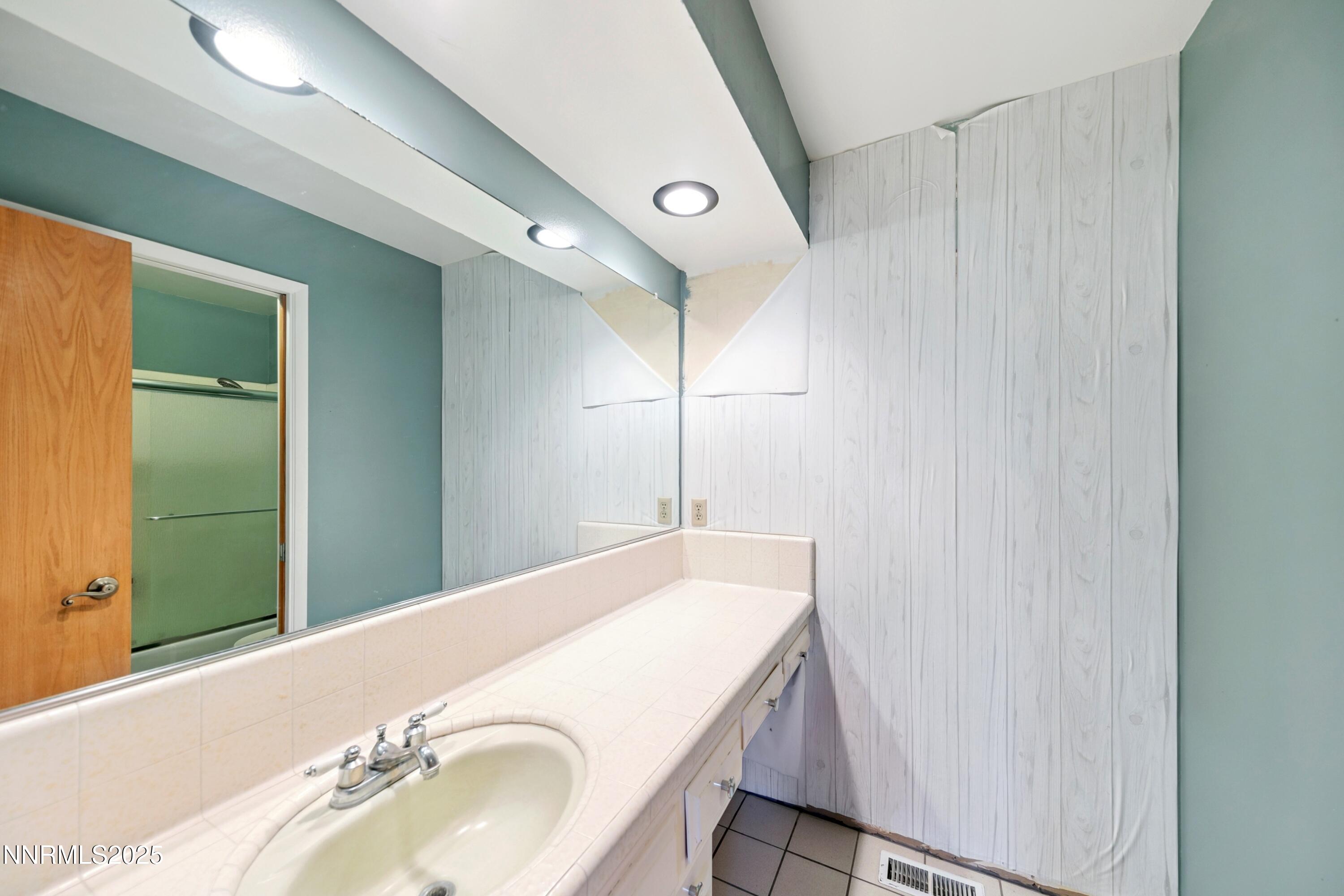 3550 Lone Tree Lane Reno, NV 89511 - Photo 31 of 40 a bathroom with a sink and a mirror