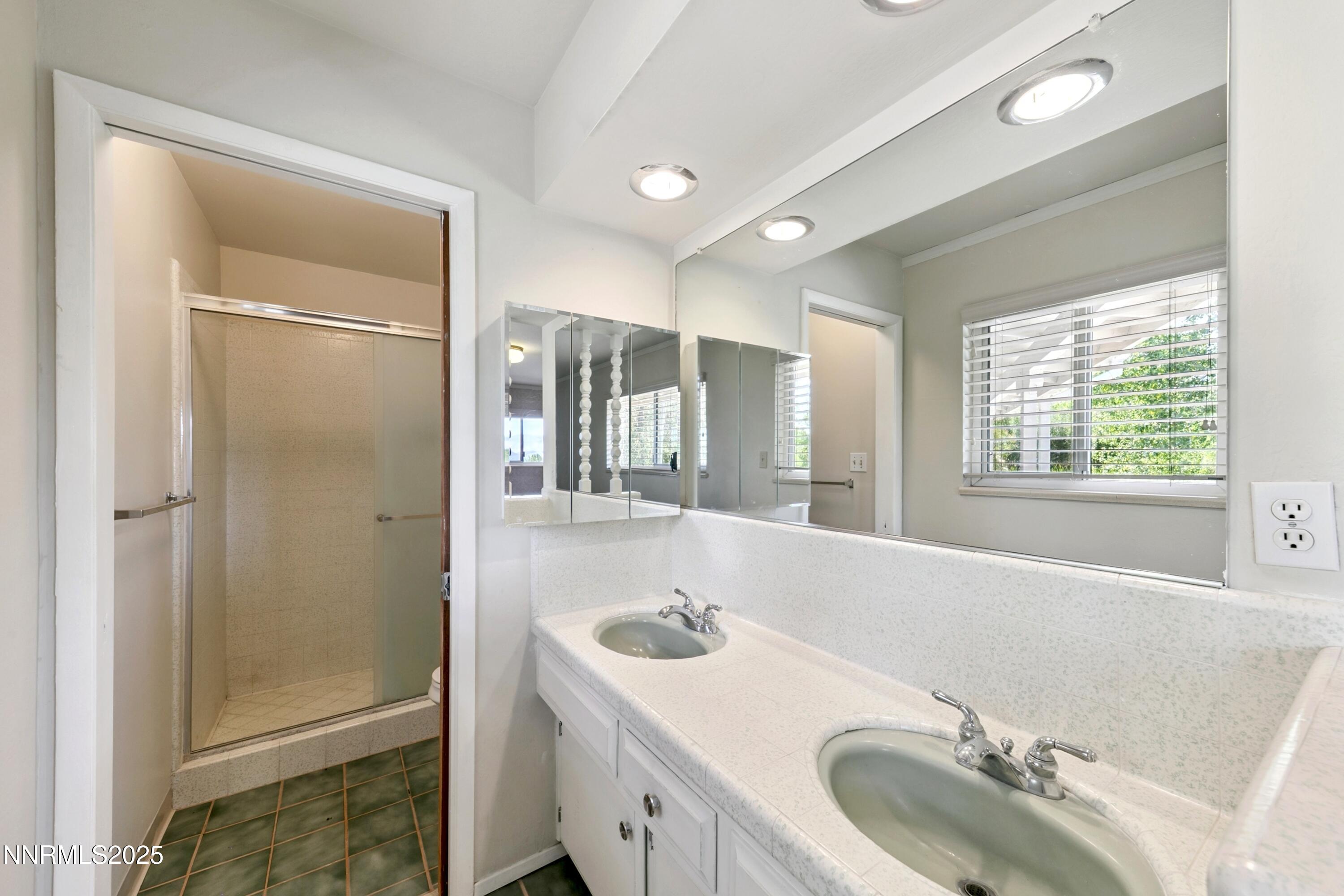 3550 Lone Tree Lane Reno, NV 89511 - Photo 34 of 40 a bathroom with a tub sink and mirror