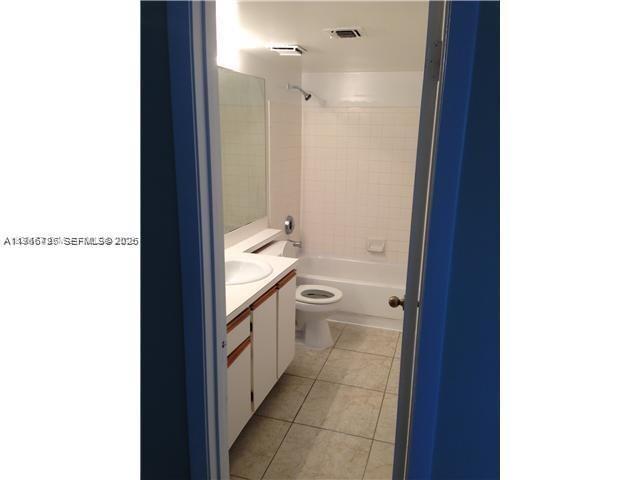 18330 Northwest 68th Avenue, Unit A Hialeah, FL 33015 - Photo 11 of 14 a bathroom with a granite countertop sink a toilet and a shower