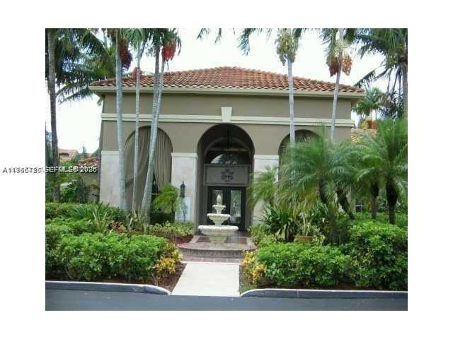 18330 Northwest 68th Avenue, Unit A Hialeah, FL 33015 - Photo 12 of 14 a front view of a house with garden