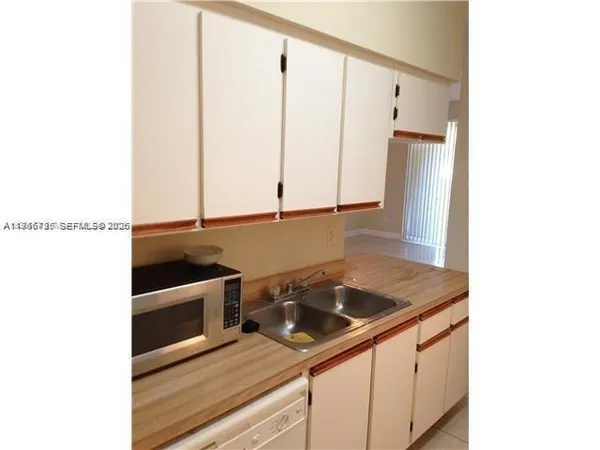 a kitchen with a sink and cabinets