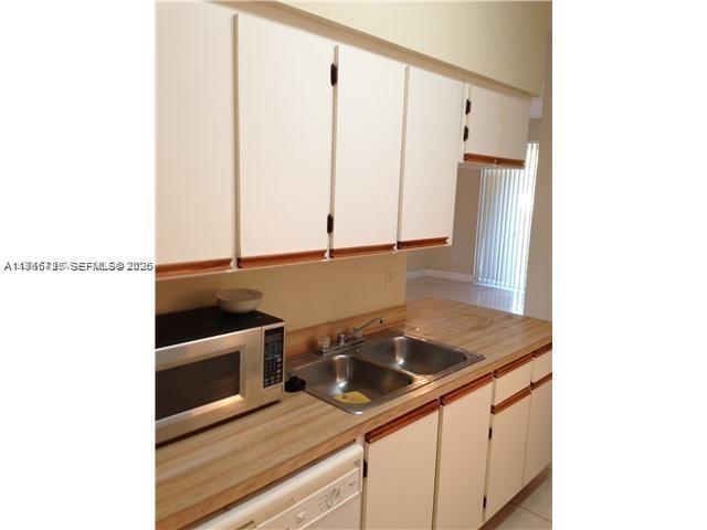 18330 Northwest 68th Avenue, Unit A Hialeah, FL 33015 - Photo 7 of 14 a kitchen with a sink and cabinets