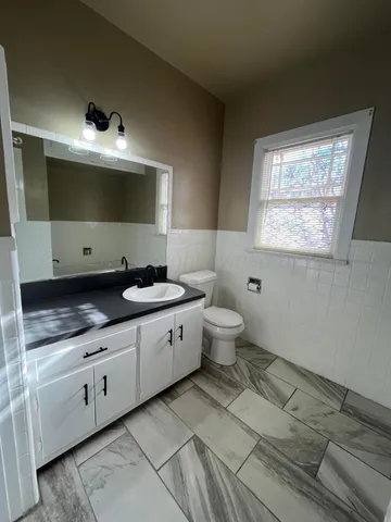 a spacious bathroom with a tub sink and mirror
