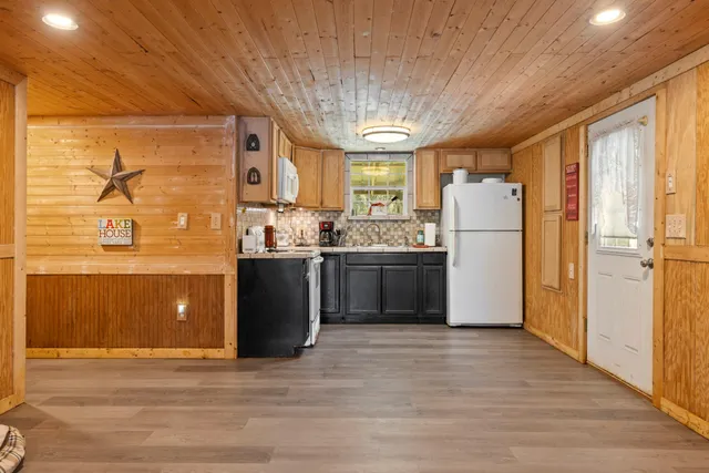 a kitchen with refrigerator and window