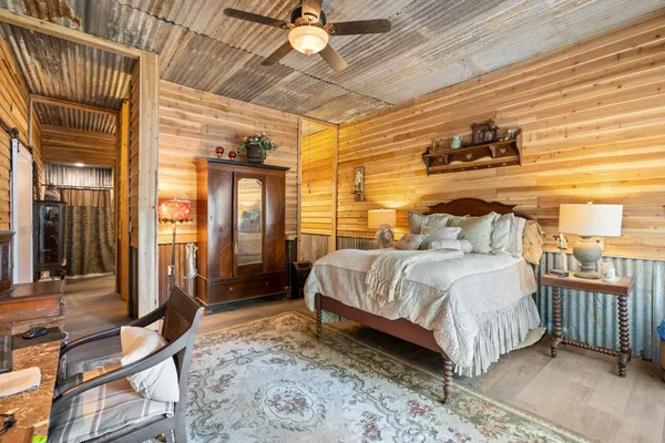 a bedroom with a large bed and a chandelier