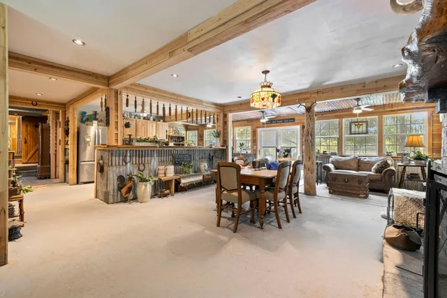 a view of a livingroom with furniture and a large window