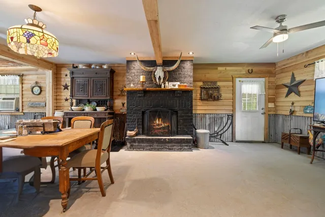 a dining room with furniture and a fireplace