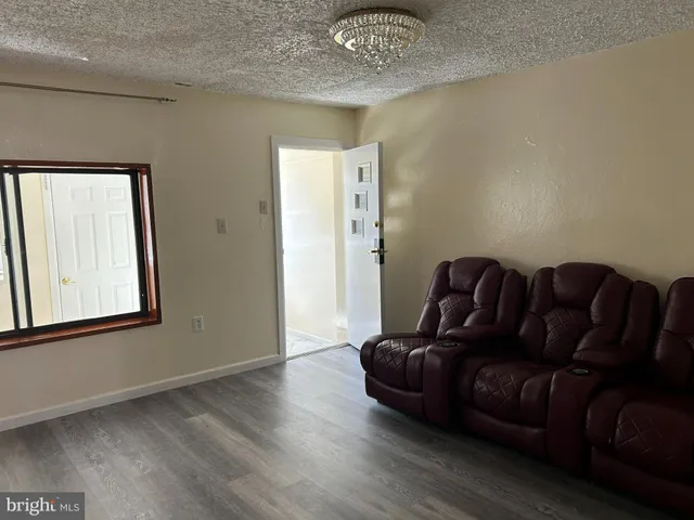 a living room with couch and wooden floor
