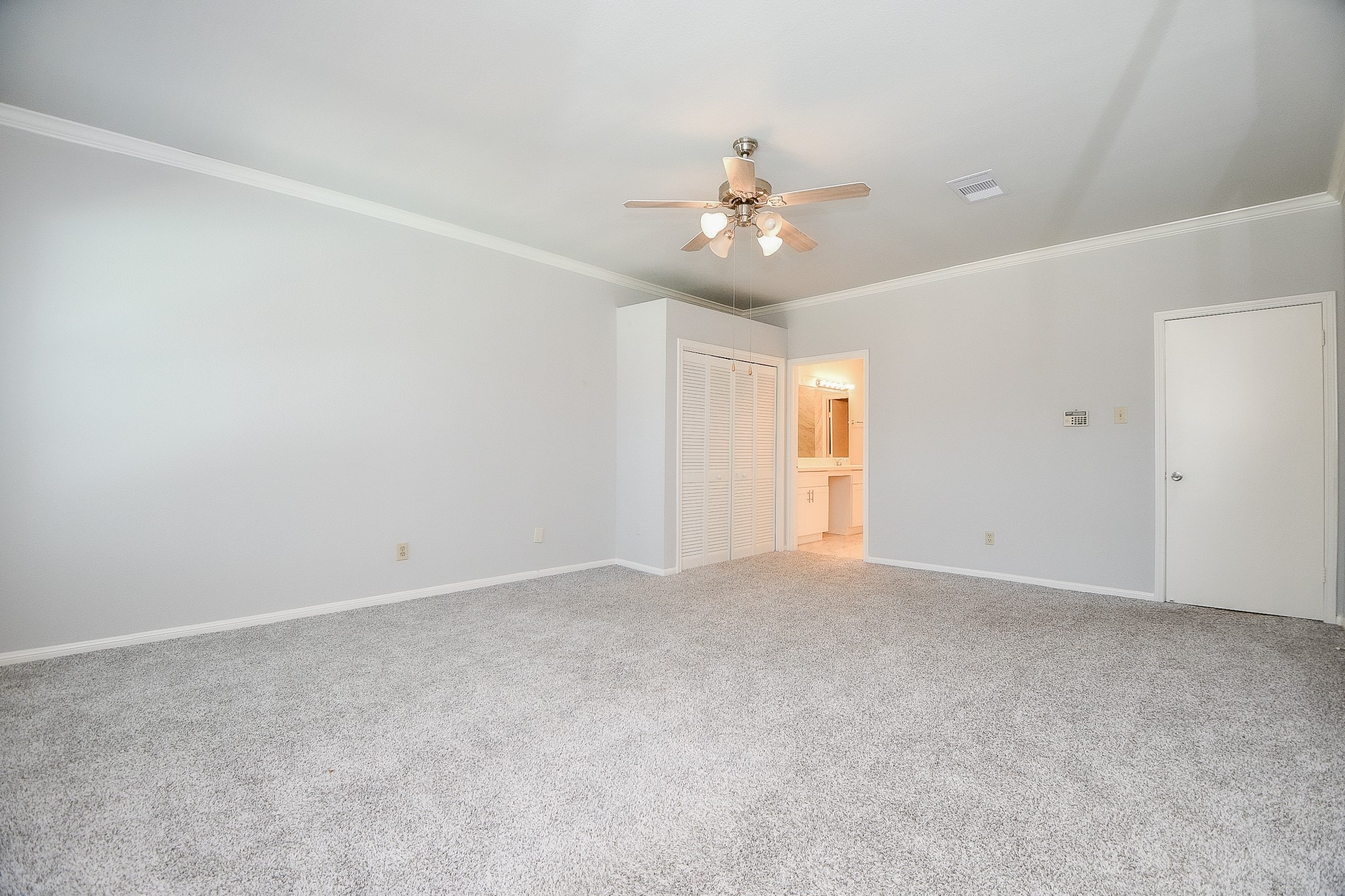 8085 El Mundo Street, Unit 8085 Houston, TX 77054 - Photo 12 of 32 an empty room with chandelier fan and windows