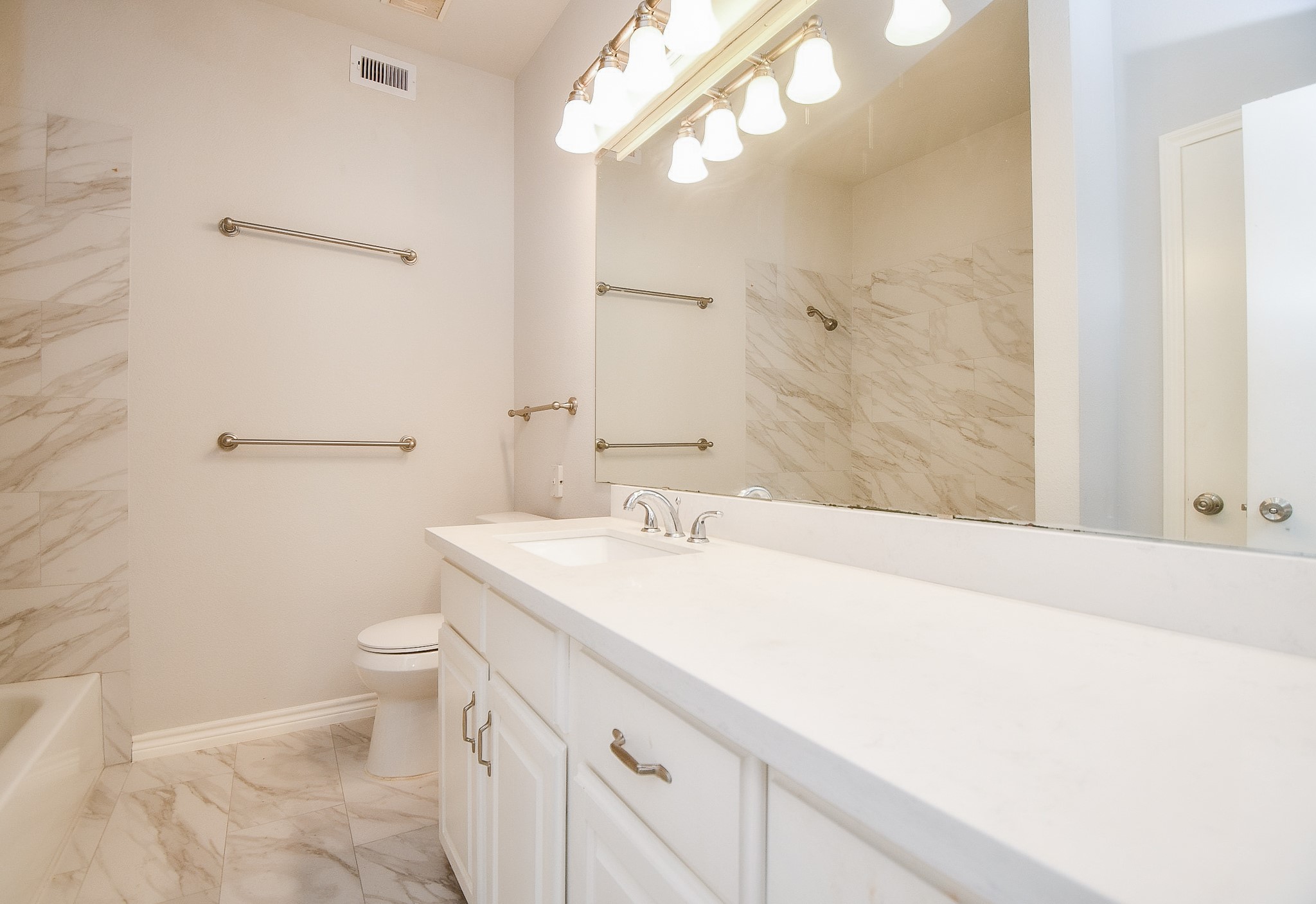 8085 El Mundo Street, Unit 8085 Houston, TX 77054 - Photo 19 of 32 a bathroom with a sink a toilet and a mirror