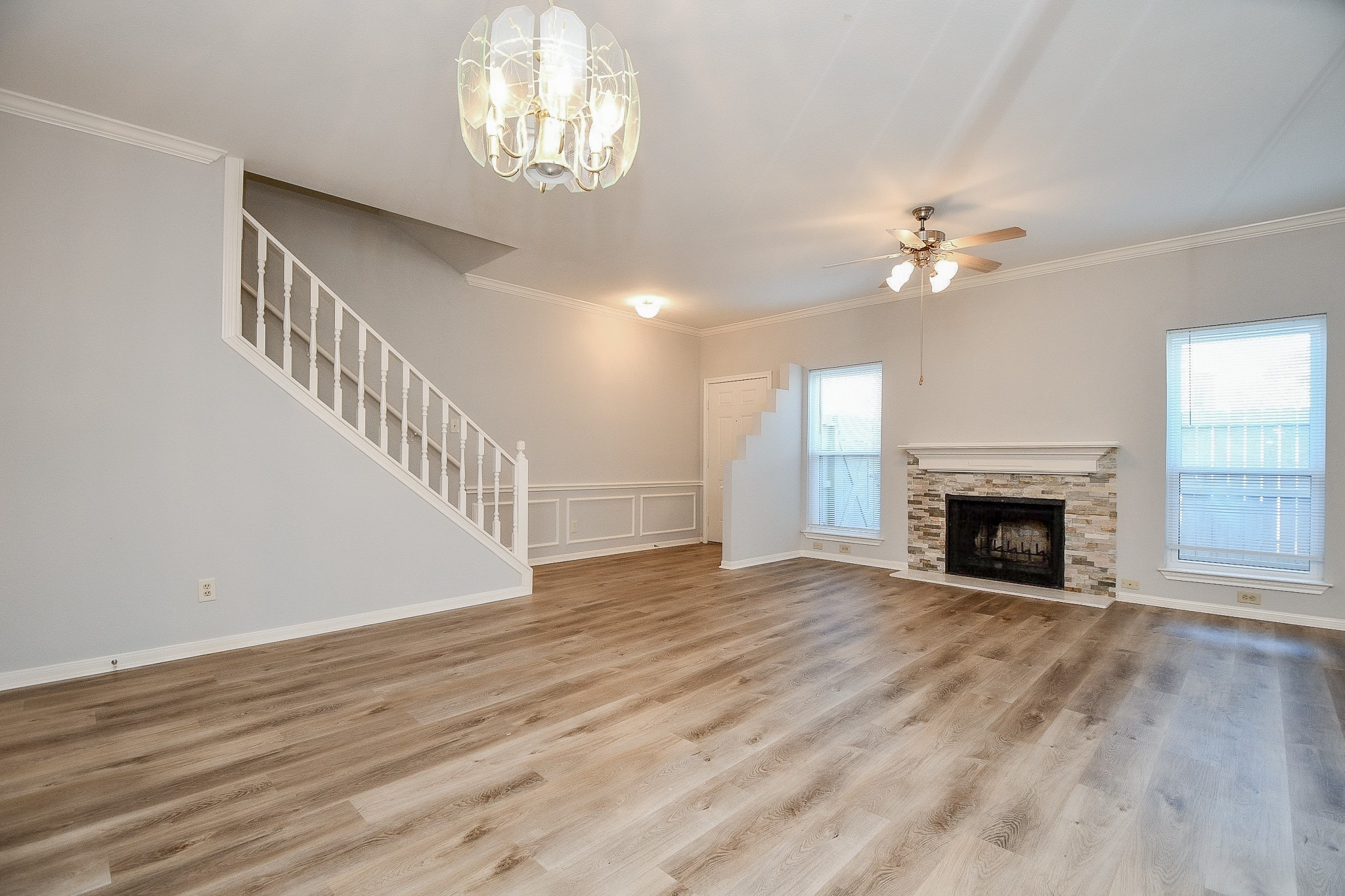 8085 El Mundo Street, Unit 8085 Houston, TX 77054 - Photo 7 of 32 wooden view of a livingroom with a fireplace a ceiling fan and windows