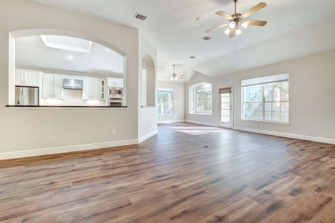 301 Rim Rock Drive Georgetown, TX 78628 - Photo 12 of 40 Living area looking into the kitchen and breakfast dining