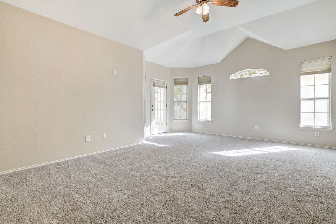 301 Rim Rock Drive Georgetown, TX 78628 - Photo 18 of 40 Recent carpeted room featuring vaulted ceiling and ceiling fan