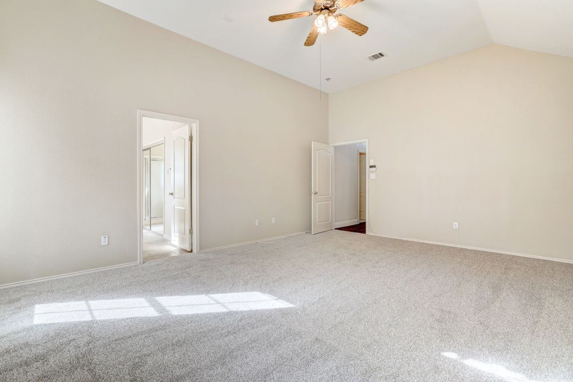 301 Rim Rock Drive Georgetown, TX 78628 - Photo 21 of 40 With recent carpet, high vaulted ceiling, and a ceiling fan