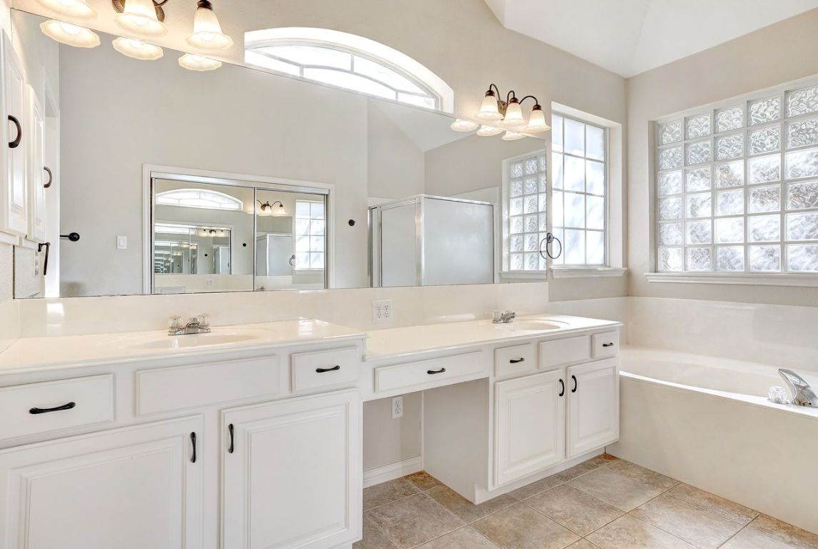 301 Rim Rock Drive Georgetown, TX 78628 - Photo 22 of 40 Full bath featuring a garden tub, double vanity, a separate shower, and light tile patterned floors