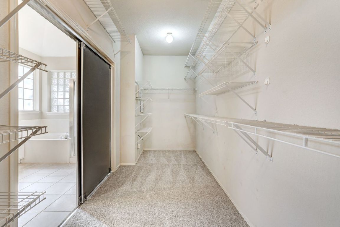 301 Rim Rock Drive Georgetown, TX 78628 - Photo 25 of 40 Spacious primary closet with light colored carpet