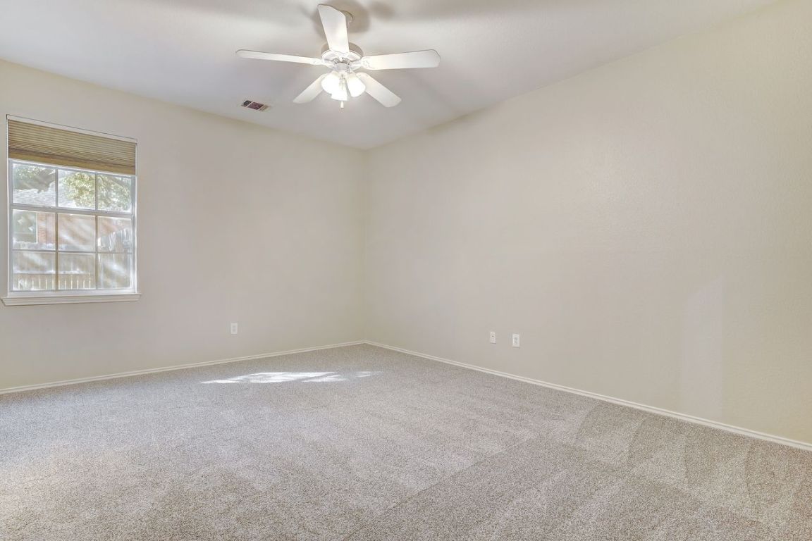 301 Rim Rock Drive Georgetown, TX 78628 - Photo 29 of 40 Bedroom featuring recent light-colored carpet and ceiling fan