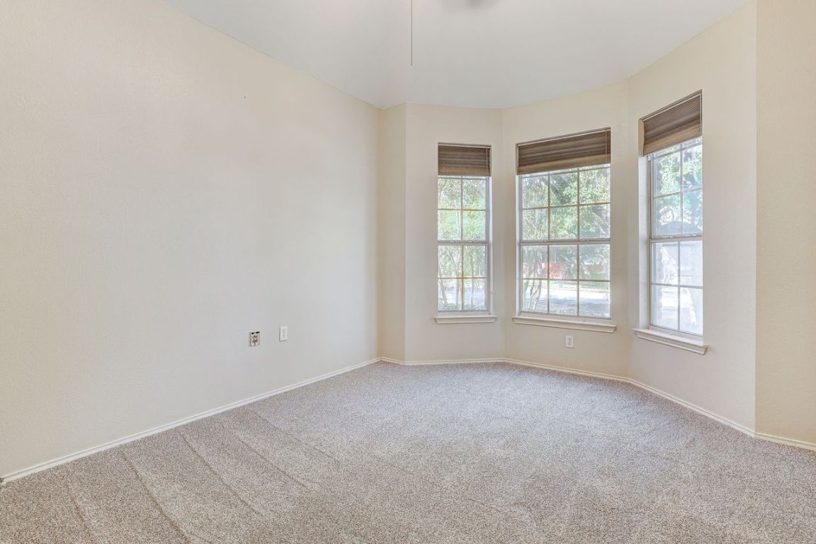 301 Rim Rock Drive Georgetown, TX 78628 - Photo 31 of 40 Spare room with healthy amount of natural light and recent carpet and bay window