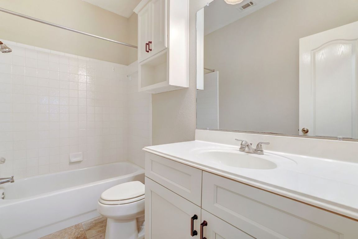 301 Rim Rock Drive Georgetown, TX 78628 - Photo 34 of 40 Full bath with shower / bathtub combination, vanity, and light tile patterned floors