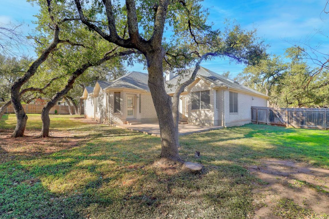 301 Rim Rock Drive Georgetown, TX 78628 - Photo 38 of 40 View of back of home with stone siding and a patio area