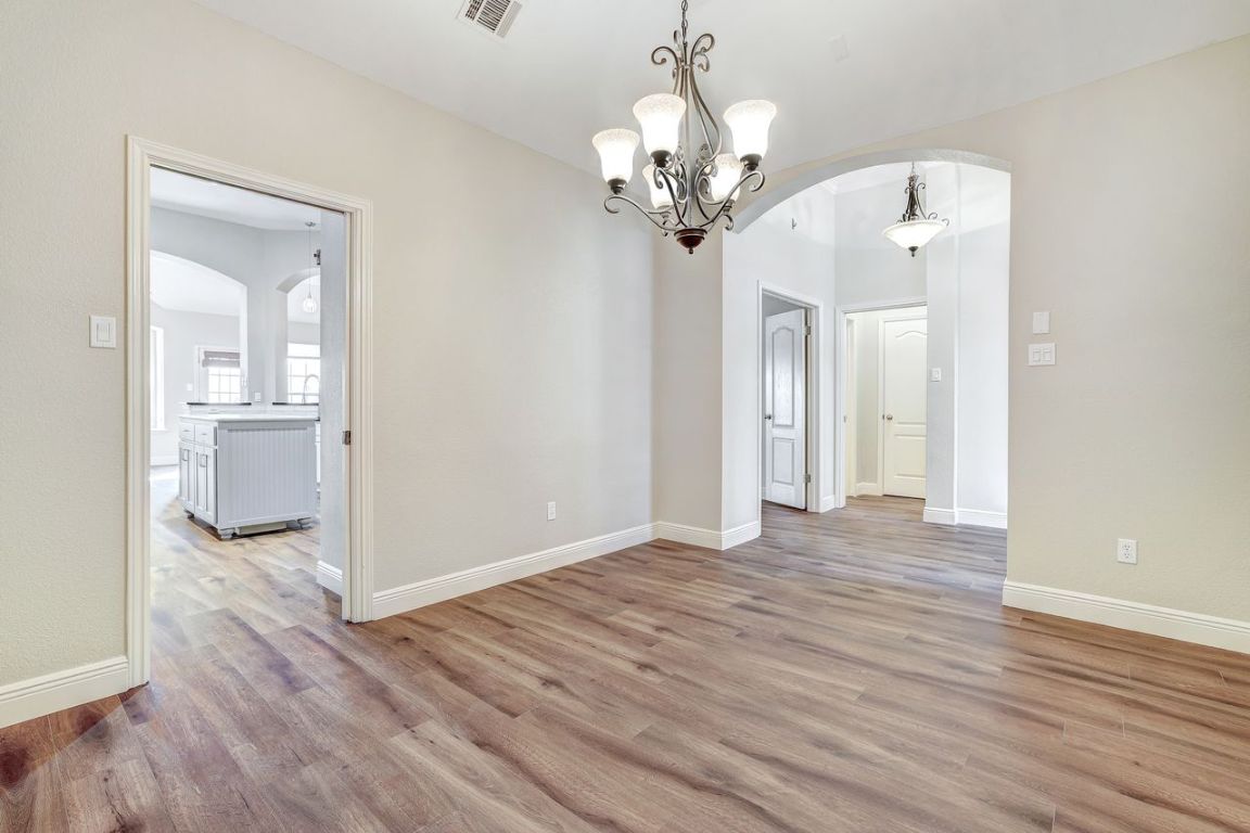 301 Rim Rock Drive Georgetown, TX 78628 - Photo 8 of 40 Formal dining looking towards the entry and kitchen