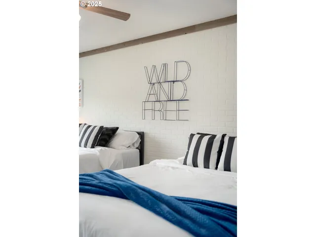 a bedroom with double bed and a chandelier