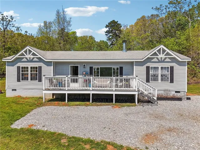 a front view of a house with a yard and balcony